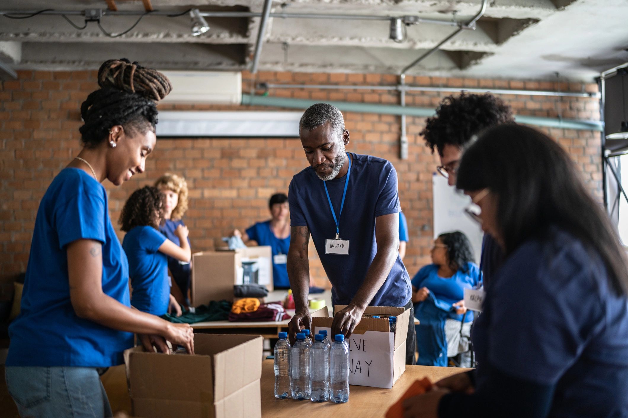 Volunteers arranging donations at a community center