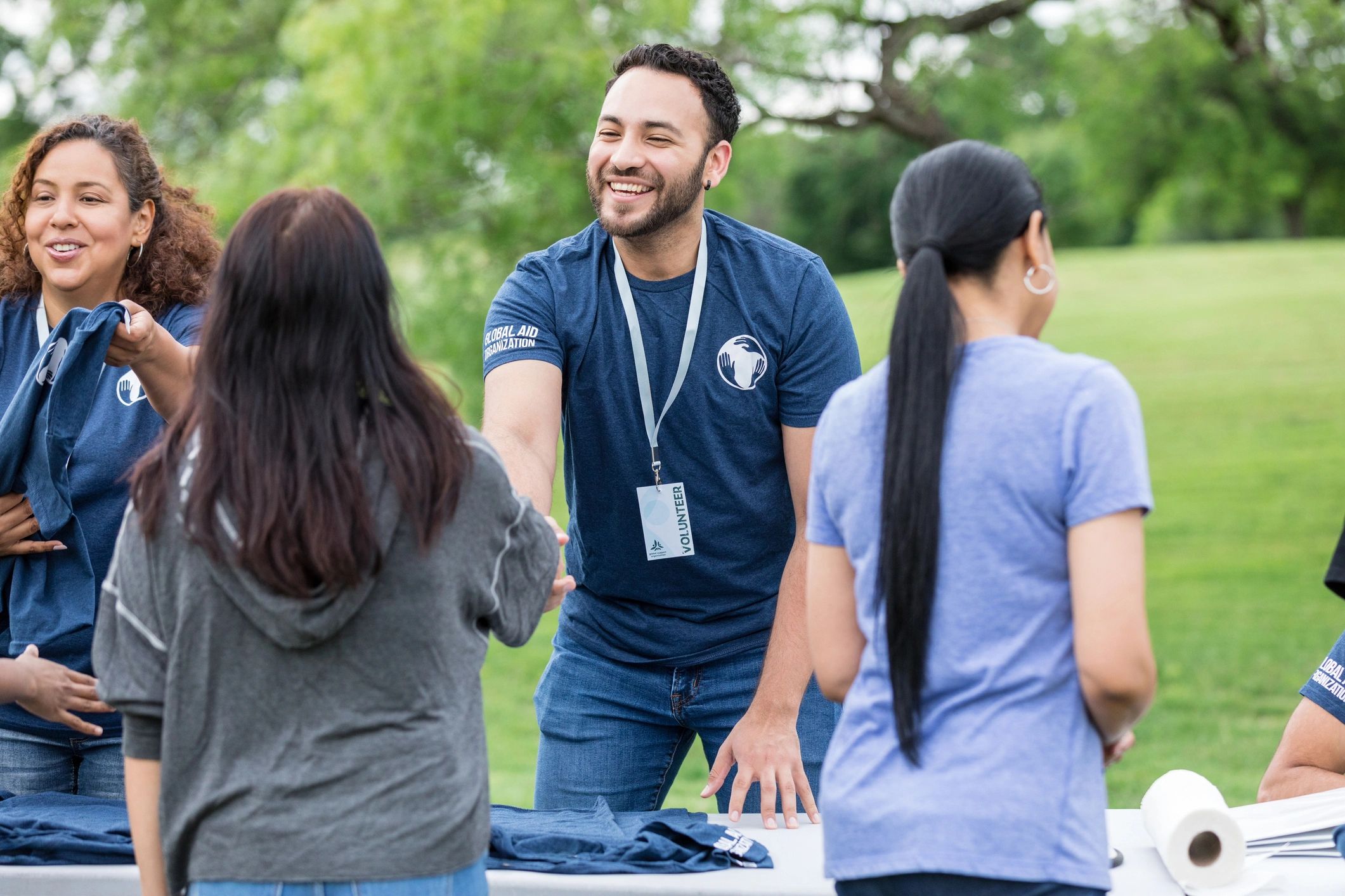 Young adult male shakes hands with the female volunteer