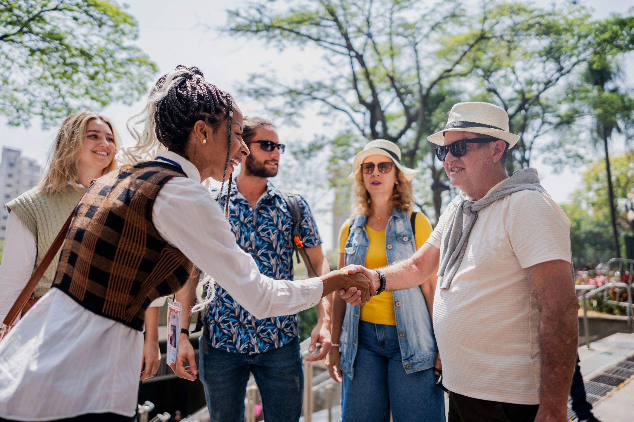 Tour guide greeting mature man in the city